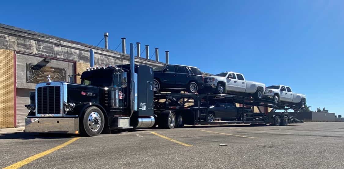 A ProN2 truck hauling two decks of cars