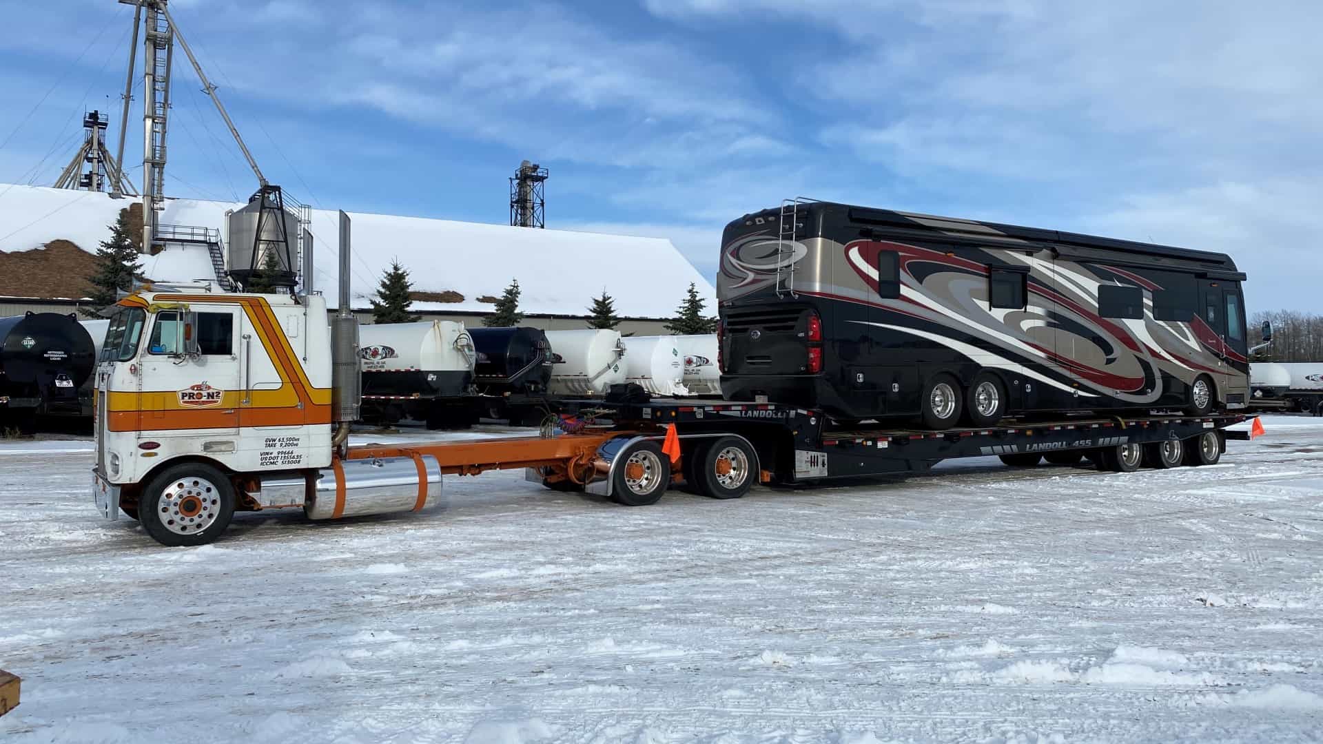 A ProN2 truck hauling an RV on a flatbed